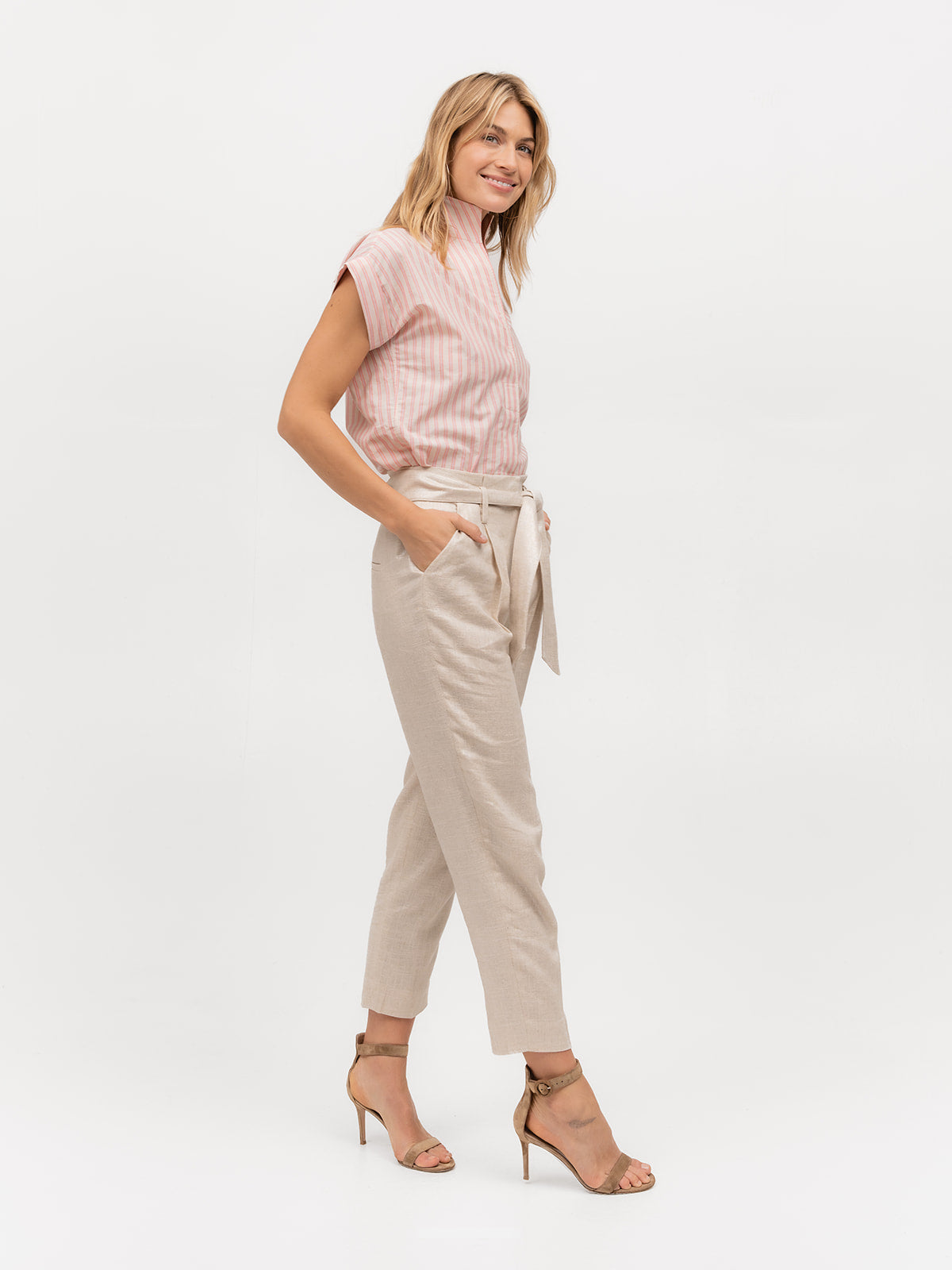 Woman smiling and wearing a pink striped short sleeve shirt